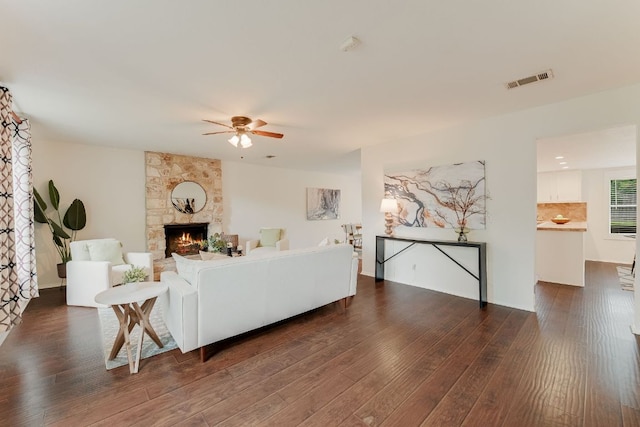4702 White Elm Dr, Austin, TX 78749 - living area with dark wood finished floors, ceiling fan, and a stone fireplace