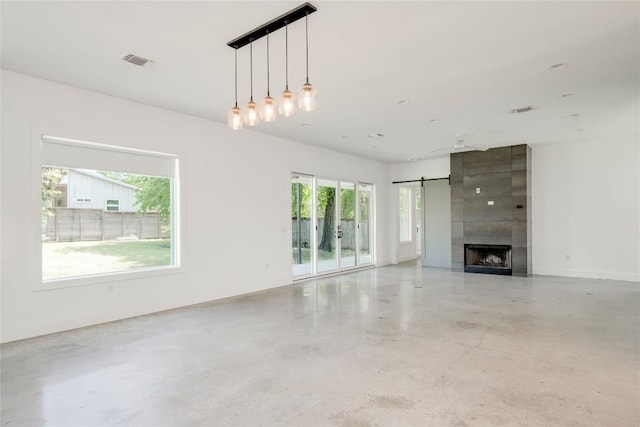 1305 Village W Dr, Austin, TX 78733 - unfurnished living room with concrete floors and a large fireplace