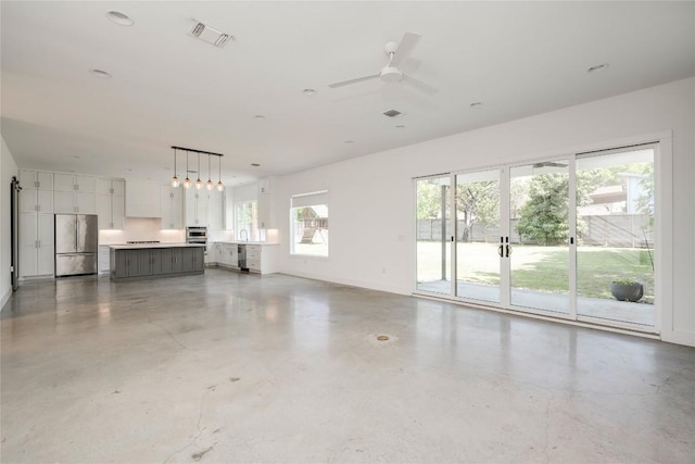 1305 Village W Dr, Austin, TX 78733 - unfurnished living room featuring a ceiling fan and baseboards