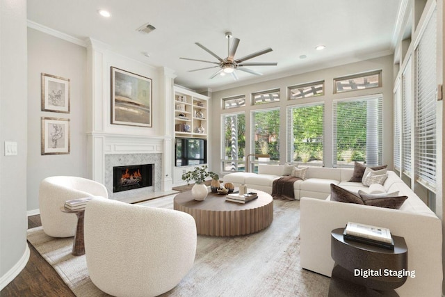 805 Parkwood Ct, Mckinney, TX 75072 - living room with wood finished floors, a ceiling fan, crown molding, a premium fireplace, and recessed lighting