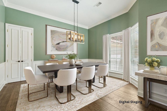 805 Parkwood Ct, Mckinney, TX 75072 - dining room with wood finished floors, crown molding, a wainscoted wall, and a chandelier