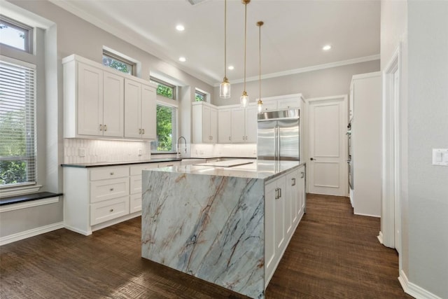 805 Parkwood Ct, Mckinney, TX 75072 - kitchen with stainless steel built in refrigerator, a center island, white cabinets, decorative backsplash, and recessed lighting