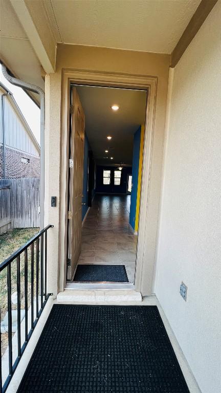 doorway to property with a balcony and stucco siding