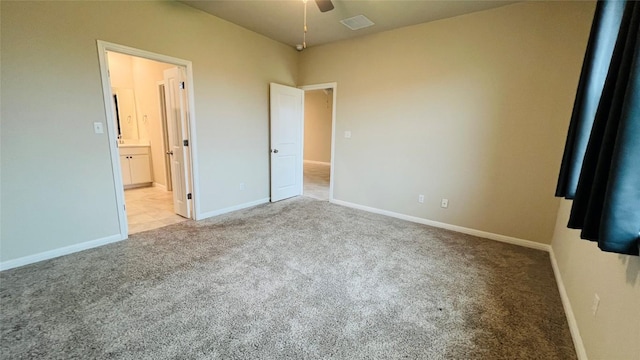 310 Dipprey Ln, Georgetown, TX 78628 - unfurnished bedroom featuring carpet floors, baseboards, and connected bathroom