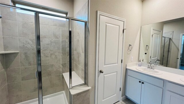 full bath featuring a shower stall and double vanity