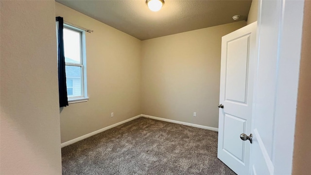 310 Dipprey Ln, Georgetown, TX 78628 - spare room with dark carpet, baseboards, and a smoke detector