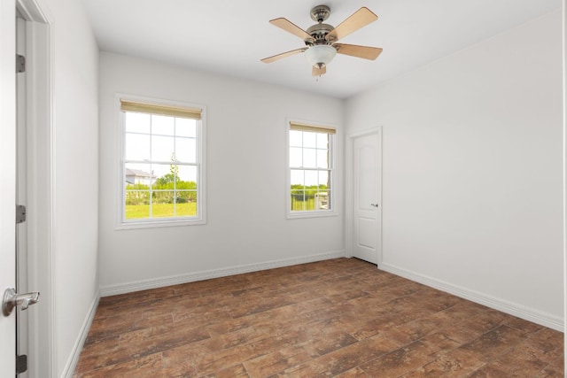 unfurnished room with baseboards, a ceiling fan, and wood finished floors