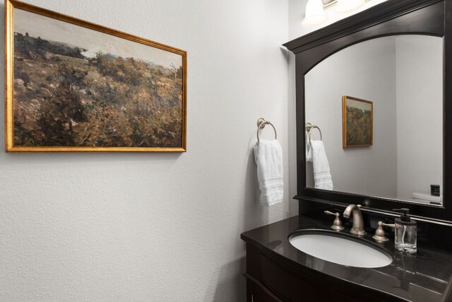 half bath featuring vanity