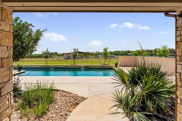 view of swimming pool with fence and a patio