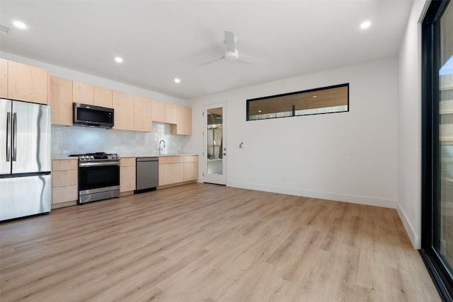 2107 Maple Ave Unit B, Austin, TX 78722 - kitchen with appliances with stainless steel finishes, light brown cabinets, light wood-style floors, light countertops, and recessed lighting