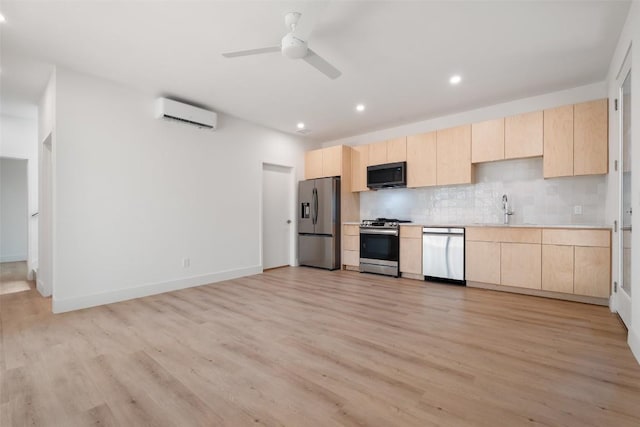 2107 Maple Ave Unit B, Austin, TX 78722 - kitchen featuring stainless steel appliances, light brown cabinets, light wood finished floors, recessed lighting, and a wall mounted AC