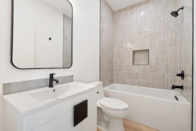 bathroom with toilet, shower / bath combination, vanity, and wood finished floors