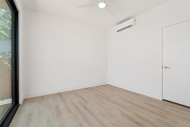 2107 Maple Ave Unit B, Austin, TX 78722 - spare room featuring an AC wall unit, wood finished floors, ceiling fan, and baseboards