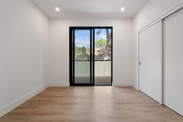 2107 Maple Ave Unit B, Austin, TX 78722 - unfurnished bedroom with access to exterior, recessed lighting, light wood-style floors, baseboards, and a closet
