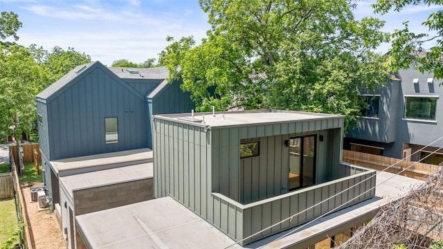 2107 Maple Ave Unit B, Austin, TX 78722 - back of house featuring a garage, board and batten siding, and driveway