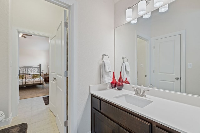 ensuite bathroom featuring vanity, tile patterned floors, and toilet