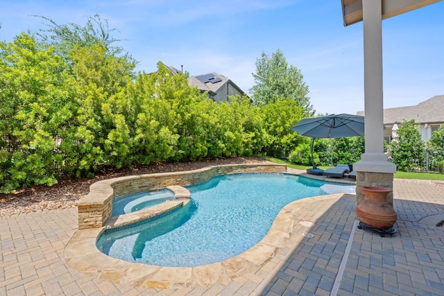 view of swimming pool featuring a patio area and a pool with connected hot tub
