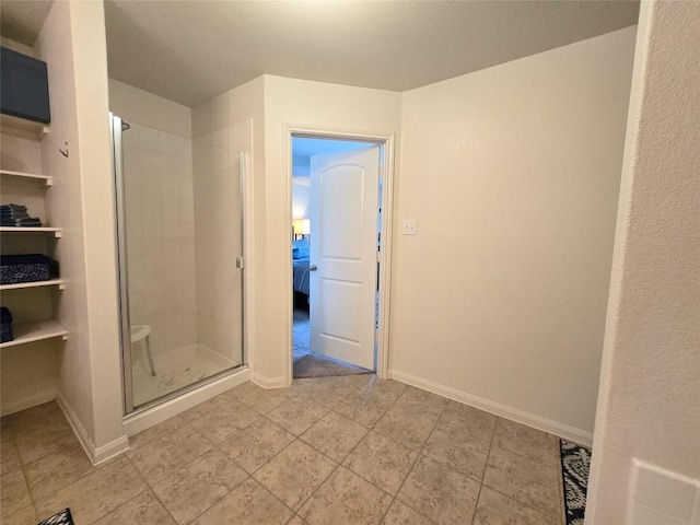 336 Farmer Ln, Jarrell, TX 76537 - bathroom with a stall shower, baseboards, and tile patterned flooring