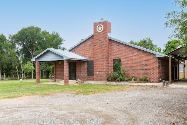 176 Old Lexington Rd Unit C, Elgin, TX 78621 - view of property exterior with a chimney, a yard, and brick siding