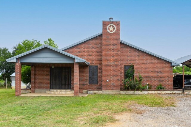 176 Old Lexington Rd Unit C, Elgin, TX 78621 - rear view of property with a lawn, a chimney, and brick siding