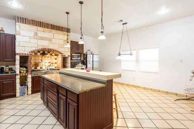 176 Old Lexington Rd Unit C, Elgin, TX 78621 - kitchen featuring stainless steel appliances, backsplash, a kitchen island, and light tile patterned flooring