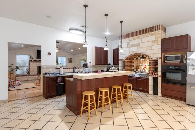 176 Old Lexington Rd Unit C, Elgin, TX 78621 - kitchen with stainless steel appliances, lofted ceiling, decorative backsplash, ceiling fan, and a kitchen bar