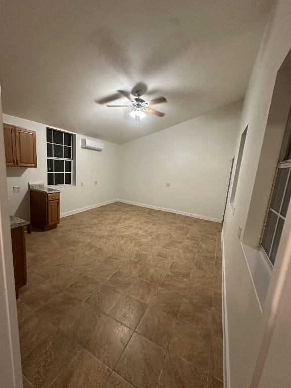176 Old Lexington Rd Unit C, Elgin, TX 78621 - unfurnished living room featuring ceiling fan and a wall mounted AC