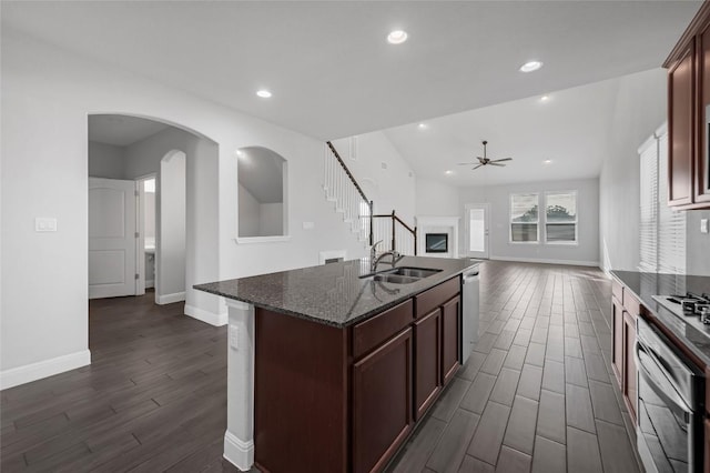 206 Duroc Dr, Hutto, TX 78634 - kitchen featuring a sink, wall oven, dark wood-style flooring, a ceiling fan, and dishwasher