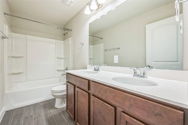 206 Duroc Dr, Hutto, TX 78634 - bathroom with bathing tub / shower combination, toilet, double vanity, and wood tiled floors