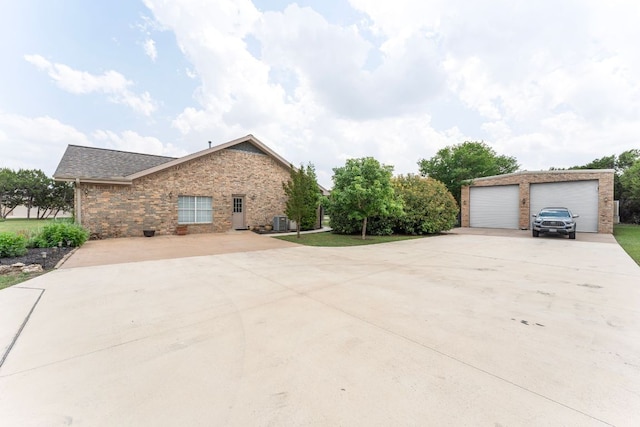 221 Breakaway Rd, Cedar Park, TX 78613 - view of home's exterior with brick siding, a garage, an outdoor structure, and central AC unit