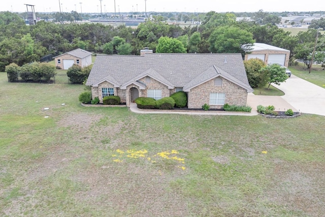 221 Breakaway Rd, Cedar Park, TX 78613 - view of front of property with stone siding, a front lawn, a chimney, a shingled roof, and a garage