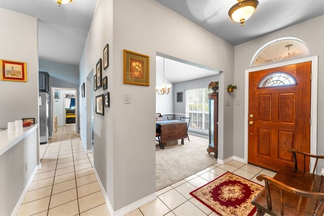 221 Breakaway Rd, Cedar Park, TX 78613 - foyer with light colored carpet, light tile patterned flooring, baseboards, and a chandelier
