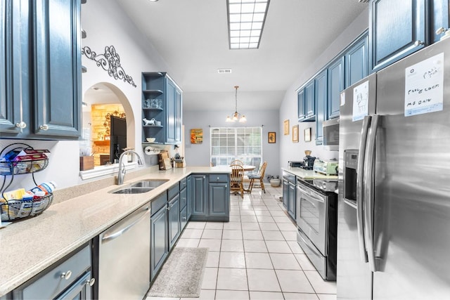 221 Breakaway Rd, Cedar Park, TX 78613 - kitchen with stainless steel appliances, a sink, open shelves, light tile patterned floors, and arched walkways
