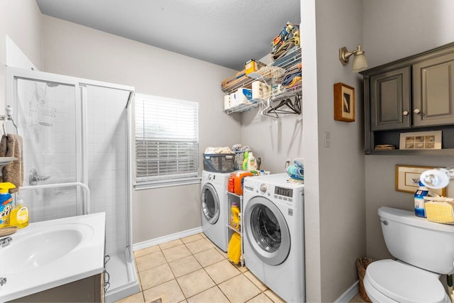 221 Breakaway Rd, Cedar Park, TX 78613 - bathroom featuring independent washer and dryer, a shower stall, toilet, tile patterned floors, and a sink
