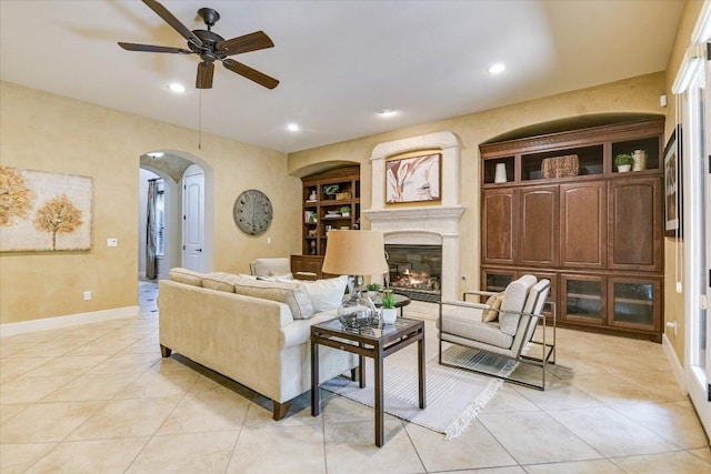 1036 Liberty Park Dr Unit 20, Austin, TX 78746 - living area with arched walkways, a ceiling fan, recessed lighting, baseboards, and built in shelves