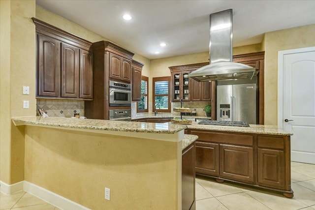 1036 Liberty Park Dr Unit 20, Austin, TX 78746 - kitchen with appliances with stainless steel finishes, island range hood, tasteful backsplash, light tile patterned floors, and recessed lighting