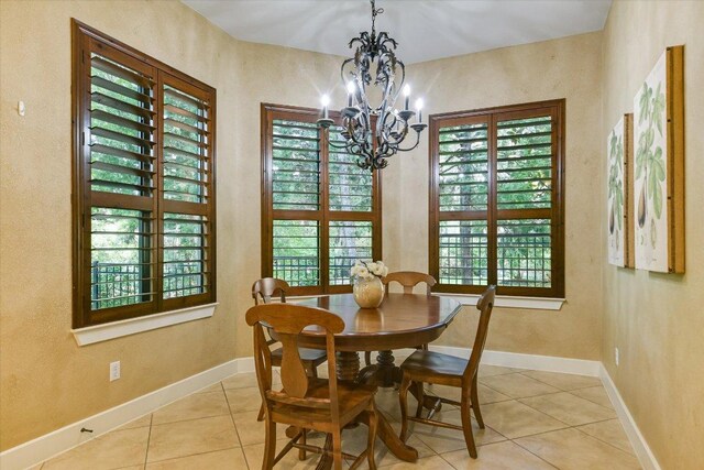 1036 Liberty Park Dr Unit 20, Austin, TX 78746 - dining area with a chandelier, light tile patterned floors, baseboards, and plenty of natural light