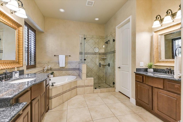 1036 Liberty Park Dr Unit 20, Austin, TX 78746 - full bathroom with tile patterned flooring, a stall shower, a garden tub, two vanities, and recessed lighting
