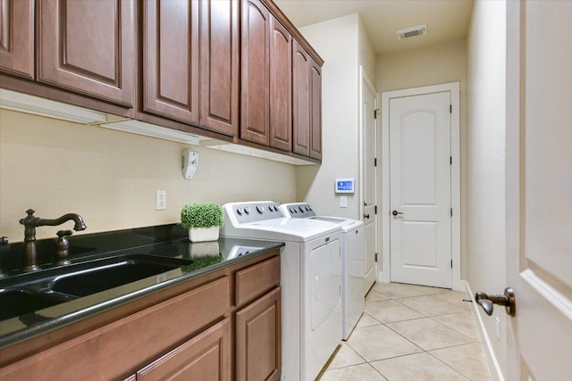 1036 Liberty Park Dr Unit 20, Austin, TX 78746 - laundry area featuring cabinet space, independent washer and dryer, light tile patterned floors, and baseboards