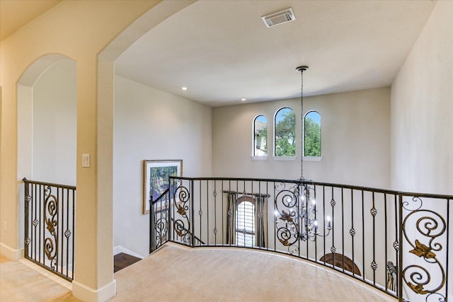 1036 Liberty Park Dr Unit 20, Austin, TX 78746 - hallway with a chandelier, baseboards, arched walkways, an upstairs landing, and wood finished floors