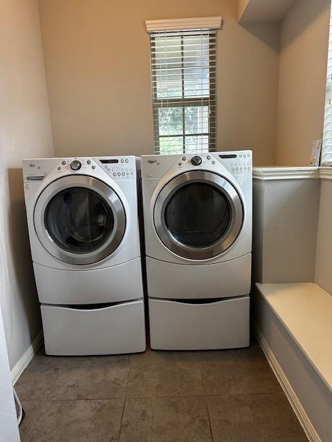 411 Tilly Ln, Buda, TX 78610 - laundry area with independent washer and dryer and tile patterned floors