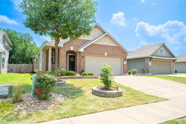 411 Tilly Ln, Buda, TX 78610 - view of front of home with brick siding, a garage, and concrete driveway