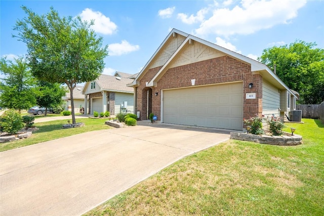 411 Tilly Ln, Buda, TX 78610 - view of front of house featuring brick siding, concrete driveway, an attached garage, and a front yard