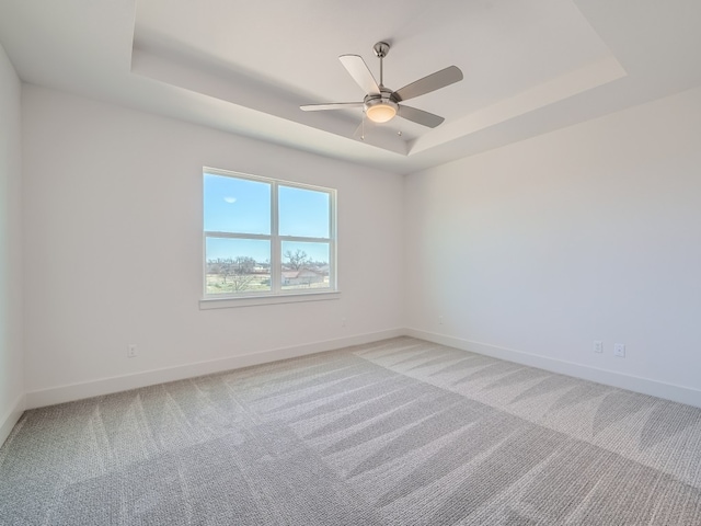 1531 N Red Bud Ln Unit 41, Round Rock, TX 78664 - unfurnished room with a tray ceiling, light colored carpet, baseboards, and a ceiling fan