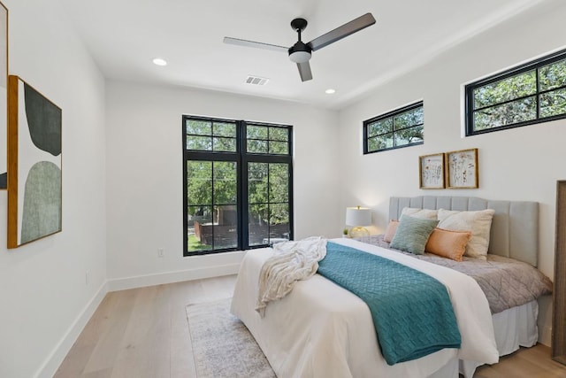 bedroom with light wood-style flooring, baseboards, recessed lighting, and a ceiling fan
