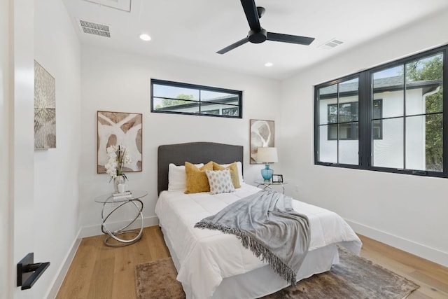 bedroom featuring light wood-style floors, baseboards, recessed lighting, and a ceiling fan