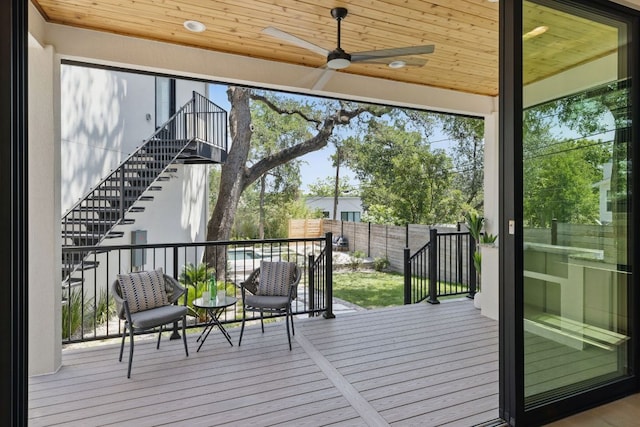 doorway to outside featuring ceiling fan, wood ceiling, and wood finished floors