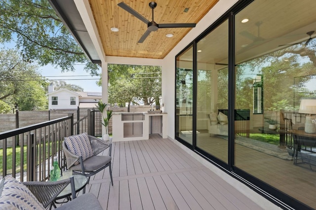 wooden deck with fence and a ceiling fan
