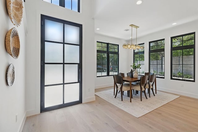 dining room with a chandelier, baseboards, light wood-type flooring, and recessed lighting