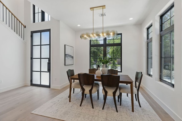 dining area featuring wood finished floors, a chandelier, baseboards, and recessed lighting